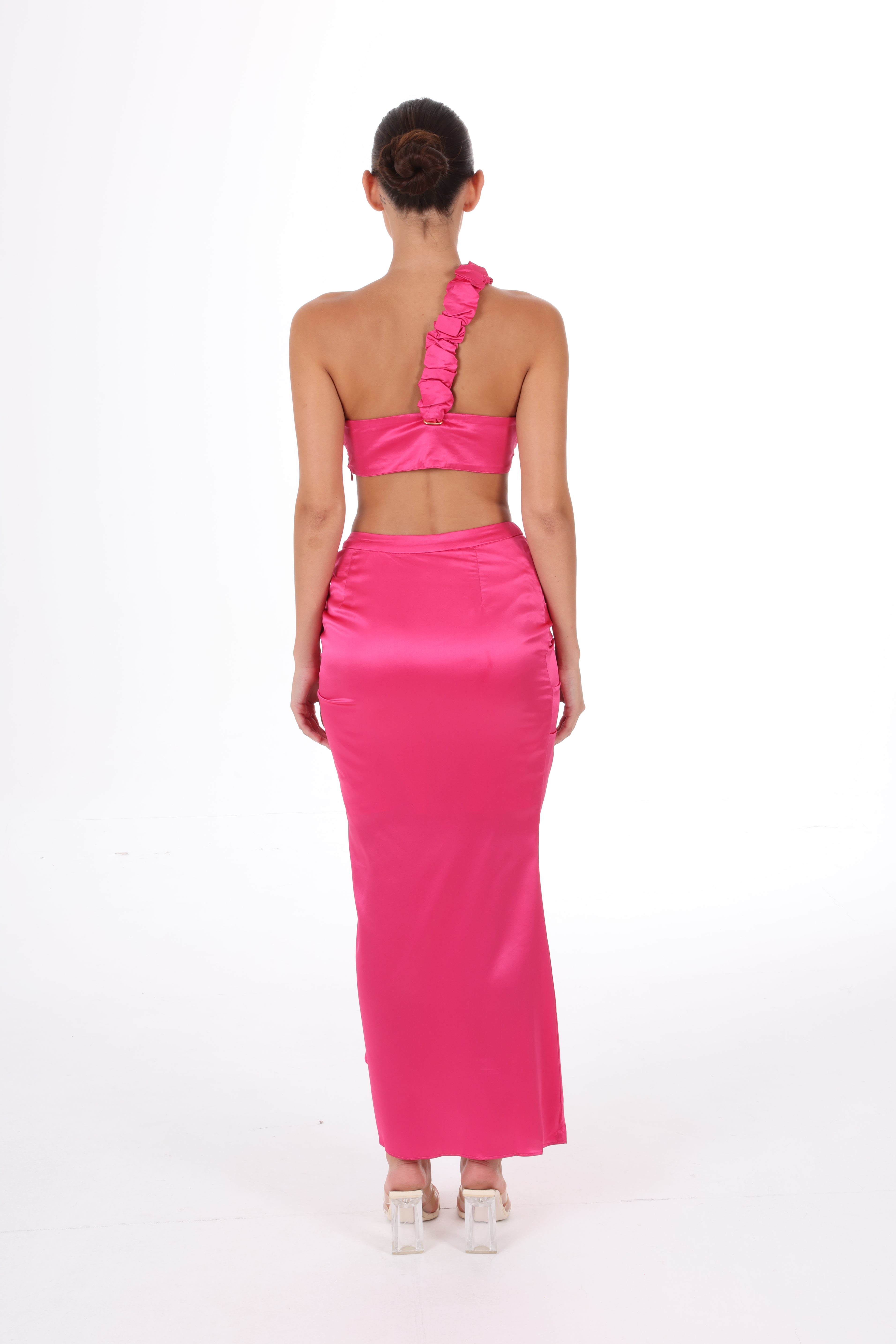 Rear view of ANAYA Set - Fuchsia Flame Satin showing fitted satin skirt and one-shoulder strap top for a sleek, elegant profile.