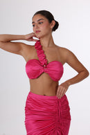 Model wearing ANAYA Set - Fuchsia Flame Satin top with ruffled one-shoulder strap and sculpted bust, part of a stylish two-piece set.