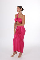Side angle of ANAYA Set - Fuchsia Flame Satin two-piece showing ruched skirt and asymmetrical strap for a chic, modern look.